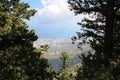 View from above between the branches of trees from the castle of Saint Hilarion on the city of Kyrenia and the Mediterranean sea. Royalty Free Stock Photo