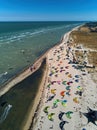 View from above of bright colorful kites lying parked on beach on windy day at kitesurfing spot. A lot of parachutes for Royalty Free Stock Photo