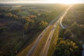 View from above of busy american highway with fast moving traffic between autumn woods. Interstate transportation