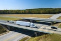 View from above of busy american highway with fast moving traffic between woods. Interstate transportation concept Royalty Free Stock Photo