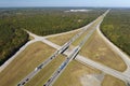 View from above of busy american highway with fast moving traffic between woods. Interstate transportation concept Royalty Free Stock Photo