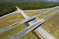 View from above of busy american highway with fast moving traffic between woods. Interstate transportation concept Royalty Free Stock Photo