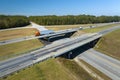 View from above of busy american highway with fast moving traffic between woods. Interstate transportation concept Royalty Free Stock Photo