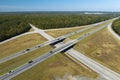 View from above of busy american highway with fast moving traffic between woods. Interstate transportation concept Royalty Free Stock Photo