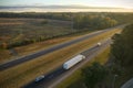 View from above of busy american highway with fast moving trucks and cars. Interstate transportation concept