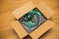 View from above of cardboard parcel box with new green wrapped gift inside Royalty Free Stock Photo