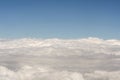 View of above clouds from airplane with blue sky background Royalty Free Stock Photo