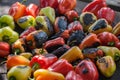 View from above of colorful red, green and yellow stuffed veggy savory bell peppers grilling on a BBQ Royalty Free Stock Photo