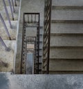 View from above of concrete spiral staircases pattern of square shape are in the old building architecture Royalty Free Stock Photo