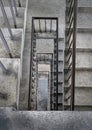 View from above of concrete spiral staircases pattern of square shape are in the old building architecture Royalty Free Stock Photo