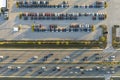 View from above of dealers outdoor parking lot with many brand new cars in stock for sale on highway side. Concept of Royalty Free Stock Photo