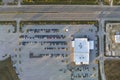 View from above of dealers outdoor parking lot with many brand new cars in stock for sale on highway side. Concept of Royalty Free Stock Photo