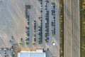 View from above of dealers outdoor parking lot with many brand new cars in stock for sale on highway side. Concept of Royalty Free Stock Photo