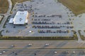 View from above of dealers outdoor parking lot with many brand new cars in stock for sale on highway side. Concept of Royalty Free Stock Photo