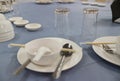 A view above the dining table features plates, bowls, spoons and glasses on a clean looking table.