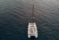 View from above drone point of view of white luxury catamaran in calm water of Atlantic Ocean