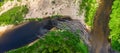 View from above of dry branch dam on the river. Sand island with green grass. Trees in the forest. Royalty Free Stock Photo