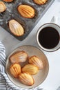 Top down view of freshly baked madeleine sponge cakes with coffee on a white marble surface Royalty Free Stock Photo