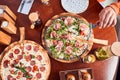 View from above of girl taking slice of pepperoni pizza Royalty Free Stock Photo