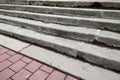 View from above of gray concrete stairs leading to colorful pavement outdoors on sunny day Royalty Free Stock Photo