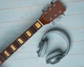 View from above of green headphones and acoustic guitar Royalty Free Stock Photo