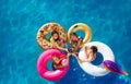 Kids party and drink soda swim in pool together