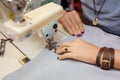 View from above on hands of female tailor working on sewing machine. dress manufacturing industry Royalty Free Stock Photo