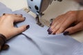 View from above on hands of female tailor working on sewing machine. dress manufacturing industry Royalty Free Stock Photo