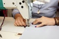 View from above on hands of female tailor working on sewing machine. dress manufacturing industry Royalty Free Stock Photo