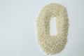 top view of a heap of rice with circular shape on white background with copy space