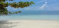 View above the lagoon with its turquoize color and the beach, shade of blue between sea and sky