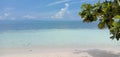 View above the lagoon with its turquoize color and the beach, shade of blue between sea and sky