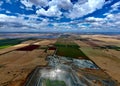 the view from above a large field with some fields and lots of grass