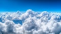 A view from above, looking down on a layer of clouds under a pristine blue sky Royalty Free Stock Photo