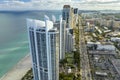 View from above of luxurious highrise hotels and condos on Atlantic ocean shore in Sunny Isles Beach city. Urban street