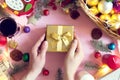 View from above on man holding gift on the Christmas decotated wooden table