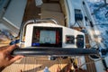 View from above of a man steering a sailing yacht using navigation display and control panel near Croatia. Precision Royalty Free Stock Photo