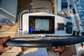 View from above of a man steering a sailing yacht using navigation display and control panel near Croatia. Precision Royalty Free Stock Photo