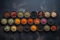 View from above of numerous spices in small bowls on a dark slate plate with copy space created with generative AI technology