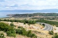 View from above on the Ohrid Lake, fishing village Lin and winding mountain road. Royalty Free Stock Photo