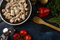 View from above of pan with raw chopped meat on dark blue background. Backstage of cooking festive dinner with frying meat for Royalty Free Stock Photo