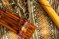 View from above of Peruvian pan flute and rain stick on colorful traditional textile. Concept of traditional Andean music Royalty Free Stock Photo
