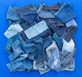 Pieces of cloth jeans on a blue background.