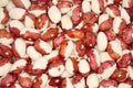 View from above on a pile of raw red with white speckled kidney beans. Closeup