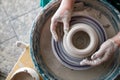 View from above of the potter`s wheel and the hands of the potter