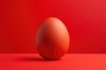 view from above,Red egg on red background close-up,light glare on egg Royalty Free Stock Photo