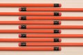 view from above of red graphite pencils with erasers placed in row Royalty Free Stock Photo