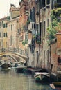 Romantic city of venice at sunset with three gondoliers on water