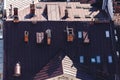 View from above on roof of old house. brown iron sheet roof with roof windows and chimneys Royalty Free Stock Photo