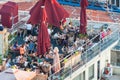View from above on roof top restaurant with patrons having meals and relaxing